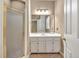 Bathroom with a shower stall, a vanity with a white countertop, and a large mirror at 2330 Burlington Ln, Snellville, GA 30078