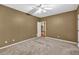 Spacious bedroom with tan walls, neutral carpet, and a ceiling fan at 2330 Burlington Ln, Snellville, GA 30078