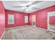 Bedroom with a ceiling fan, two windows, and a doorway to the ensuite bath at 2330 Burlington Ln, Snellville, GA 30078