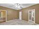 Bedroom featuring neutral walls, a ceiling fan, with doorways to a bathroom and hallway at 2330 Burlington Ln, Snellville, GA 30078
