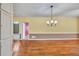 Dining room featuring hardwood floors and a classic chandelier at 2330 Burlington Ln, Snellville, GA 30078