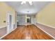 Dining room featuring hardwood floors and a classic chandelier at 2330 Burlington Ln, Snellville, GA 30078