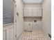 Laundry room with tile floors, utility hookups and overhead cabinets at 2330 Burlington Ln, Snellville, GA 30078