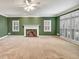 Open-concept living room with fireplace and large windows at 2330 Burlington Ln, Snellville, GA 30078