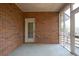 Screened porch with a brick wall and a view of the backyard at 2330 Burlington Ln, Snellville, GA 30078