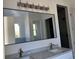 Double vanity bathroom with a large mirror and elegant fixtures at 4824 Highway 20 Se, Conyers, GA 30013