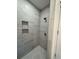 New shower with grey tiling and a pebble floor at 4824 Highway 20 Se, Conyers, GA 30013
