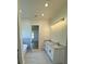 Bathroom with double vanity, tub, modern lighting and neutral colors at 4824 Highway 20 Se, Conyers, GA 30013