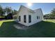 Side view of a charming house with white siding, black windows, and green grass at 4824 Highway 20 Se, Conyers, GA 30013