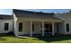 Back exterior of house with porch featuring white columns, sliding doors, and a ceiling fan at 4824 Highway 20 Se, Conyers, GA 30013