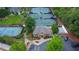 Aerial view of community tennis courts and clubhouse surrounded by lush green trees and greenery at 5450 Piney Grove Dr, Cumming, GA 30040