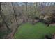 A sprawling backyard with a fenced-in area, lush trees, and a tranquil forest backdrop at 5450 Piney Grove Dr, Cumming, GA 30040