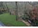 Lush backyard with stone steps leading to a secluded wooded area and bench seating at 5450 Piney Grove Dr, Cumming, GA 30040