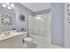 Bathroom featuring blue walls, framed mirror, toilet, and shower-tub combination at 5450 Piney Grove Dr, Cumming, GA 30040