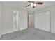 Bedroom features plush carpet, ceiling fan, and double door closet at 5450 Piney Grove Dr, Cumming, GA 30040