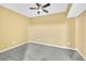 Bedroom with carpet, ceiling fan, and neutral paint colors at 5450 Piney Grove Dr, Cumming, GA 30040