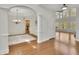 Open dining area with elegant chandelier and large windows for natural light with hardwood floors at 5450 Piney Grove Dr, Cumming, GA 30040