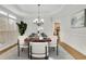 Dining room boasts a stylish rug and a decorative chandelier, ideal for Gathering gatherings at 5450 Piney Grove Dr, Cumming, GA 30040