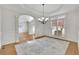 Formal dining room with tray ceiling, wainscoting, and designer chandelier fixture at 5450 Piney Grove Dr, Cumming, GA 30040