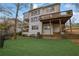 Back exterior of a two-story home featuring a large backyard and two-level deck at 5450 Piney Grove Dr, Cumming, GA 30040