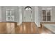 Entryway with hardwood floors, white pillars, and natural light, perfect for welcoming guests at 5450 Piney Grove Dr, Cumming, GA 30040