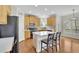 Kitchen featuring wood cabinets, stainless steel appliances, and island with breakfast bar at 5450 Piney Grove Dr, Cumming, GA 30040