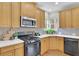 Kitchen featuring white countertops, stainless steel microwave, and black stove at 5450 Piney Grove Dr, Cumming, GA 30040