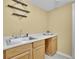 Functional laundry room featuring wood cabinets and a stainless steel sink at 5450 Piney Grove Dr, Cumming, GA 30040