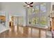 Spacious living room with hardwood floors, large windows, and a staircase at 5450 Piney Grove Dr, Cumming, GA 30040