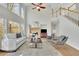 Bright and airy living room with high ceilings and large windows, featuring a fireplace at 5450 Piney Grove Dr, Cumming, GA 30040