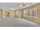 Spacious living room with wall-to-wall carpet, large windows, and recessed lighting at 5450 Piney Grove Dr, Cumming, GA 30040