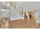 Bright, open-concept living room features hardwood floors and an adjacent kitchen with modern appliances at 5450 Piney Grove Dr, Cumming, GA 30040