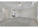 Airy bedroom with en-suite bathroom featuring neutral decor, carpet, and tray ceiling at 5450 Piney Grove Dr, Cumming, GA 30040