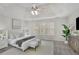 Bright main bedroom featuring a tray ceiling, large windows, and neutral décor at 5450 Piney Grove Dr, Cumming, GA 30040