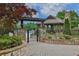 Community pool featuring a pergola covered entrance and outdoor lounge area at 5450 Piney Grove Dr, Cumming, GA 30040