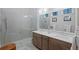 Modern bathroom with double vanity, frameless glass shower, and elegant fixtures at 756 Stickley Oak Way, Woodstock, GA 30189