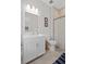 Well-lit bathroom featuring a vanity with white cabinets, a framed mirror, and a shower with a curtain at 756 Stickley Oak Way, Woodstock, GA 30189