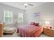 Inviting bedroom with a comfortable bed, soft lighting, and a view from the windows with natural light at 756 Stickley Oak Way, Woodstock, GA 30189