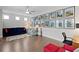 Spacious bonus room with modern lighting, hardwood floors, and a large display of framed photos at 756 Stickley Oak Way, Woodstock, GA 30189
