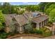 Exterior aerial view of clubhouse with shingle roof, stone accents, landscaping and paved walkway at 756 Stickley Oak Way, Woodstock, GA 30189