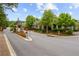Community entrance featuring stone pillars, lush landscaping, and clear signage for visitors and residents at 756 Stickley Oak Way, Woodstock, GA 30189