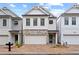 Charming two-story home with brick driveway, stone accents, white siding, and a two-car garage at 756 Stickley Oak Way, Woodstock, GA 30189