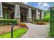 Stunning stone facade with inviting entrance and covered porch framed by colorful landscaping at 756 Stickley Oak Way, Woodstock, GA 30189