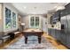 Entertaining game room with pool table, wet bar, and ample natural light at 756 Stickley Oak Way, Woodstock, GA 30189