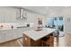 Bright, modern kitchen with white cabinets, stainless steel appliances, and a center island at 756 Stickley Oak Way, Woodstock, GA 30189