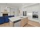 Bright kitchen features stainless steel appliances, gas cooktop, and island with quartz countertops at 756 Stickley Oak Way, Woodstock, GA 30189