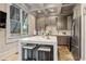 Modern kitchen features a center island, stainless steel appliances, and custom cabinetry at 756 Stickley Oak Way, Woodstock, GA 30189