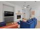 Inviting living room with a modern fireplace, plush blue sofa, and elegant decor at 756 Stickley Oak Way, Woodstock, GA 30189