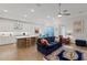 Open concept living space includes kitchen, dining area, and living room with hardwood floors at 756 Stickley Oak Way, Woodstock, GA 30189
