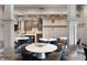 Elegant lounge area with modern decor, round tables, kitchen area, and stylish seating at 756 Stickley Oak Way, Woodstock, GA 30189